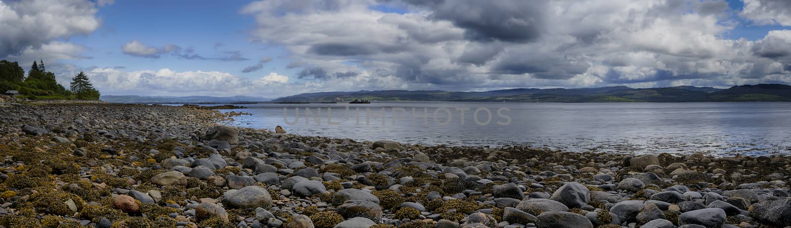 Panoramic view of rocks and boulders on the shore of the Firth of Clyde on the West coast of Scotland