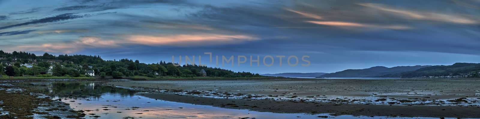 Panoramic view looking down estuary of sunset over Lochgilphead,Scotland at low tide