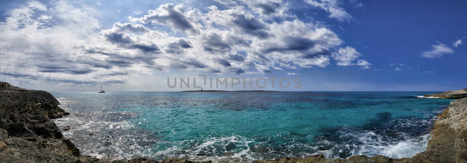 Panoramic view of lighthouse in Mediterranean sea off the coast of Menorca at Punta Prima