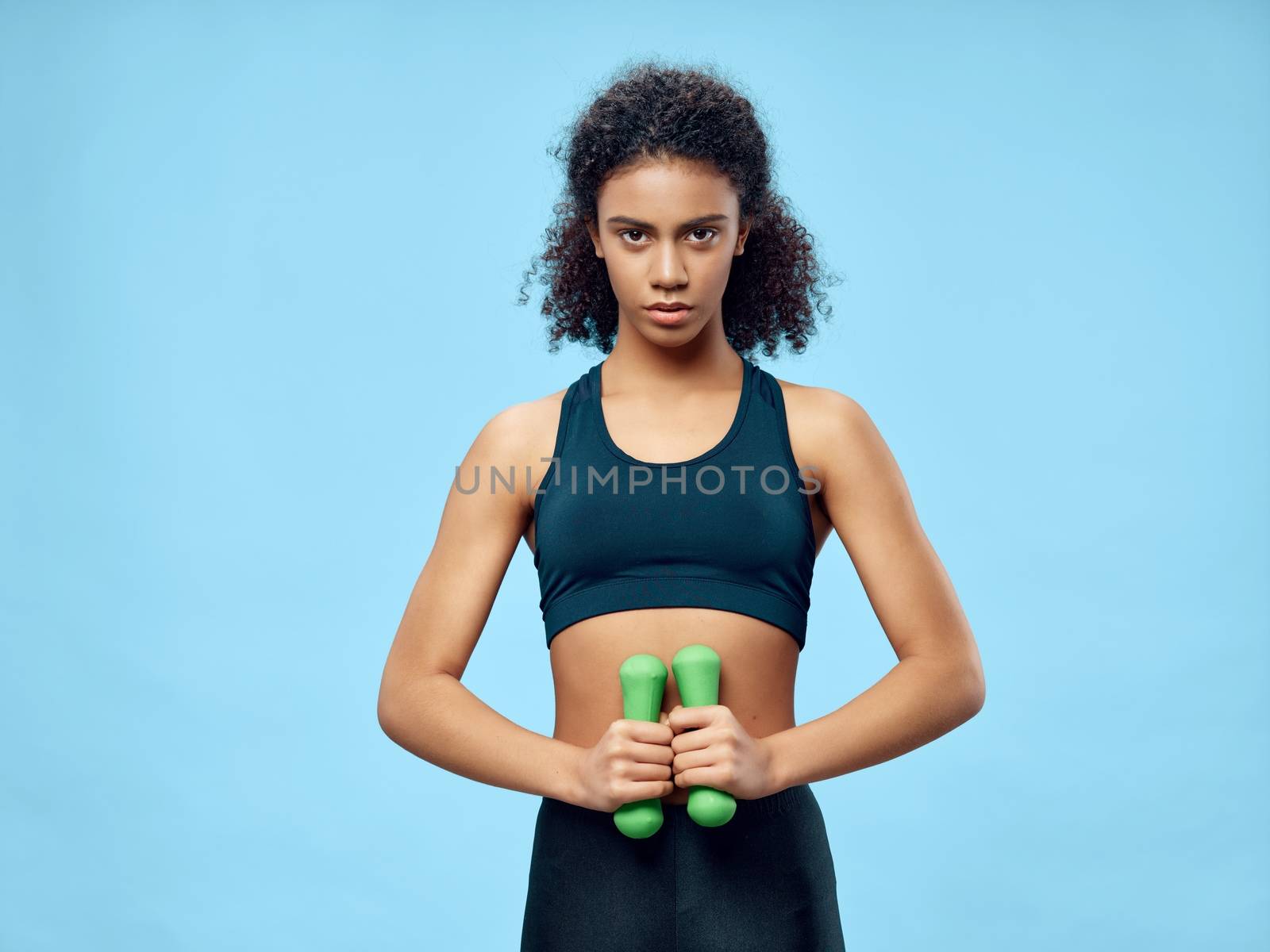 Sportive woman slim figure dumbbells exercise motivation gymnasium