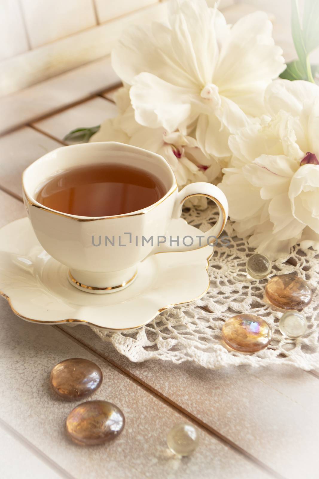 Bouquet of peonies, tea in white elegant cup, photo in gentle colors. have a nice day concept.