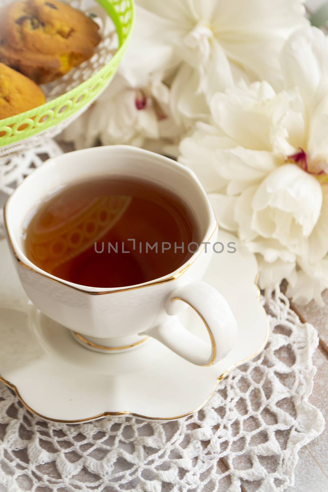 A tea party in the style of Shabby Chic. Delicate white peony white lace in retro style. On a white lace tablecloth. Vertical image