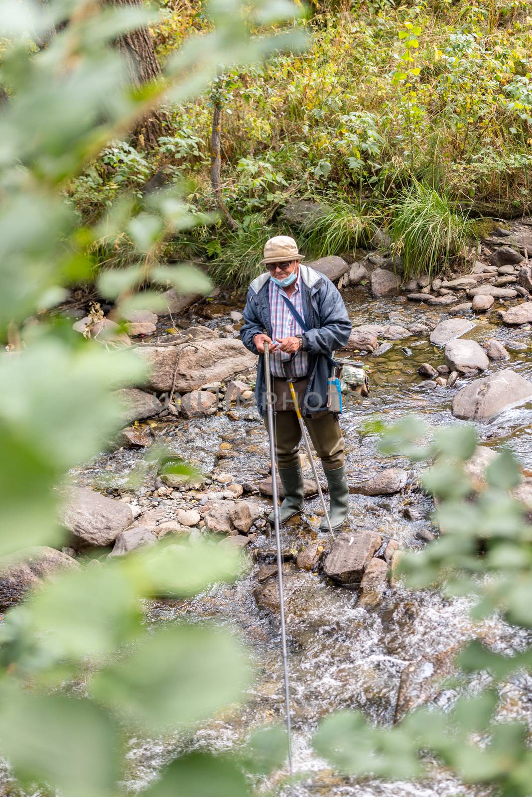 Ordino, Andorra: 26 August 2020: Fischerman enjoying the Valira del Orient river in Cami Ral in summer in Andorra.