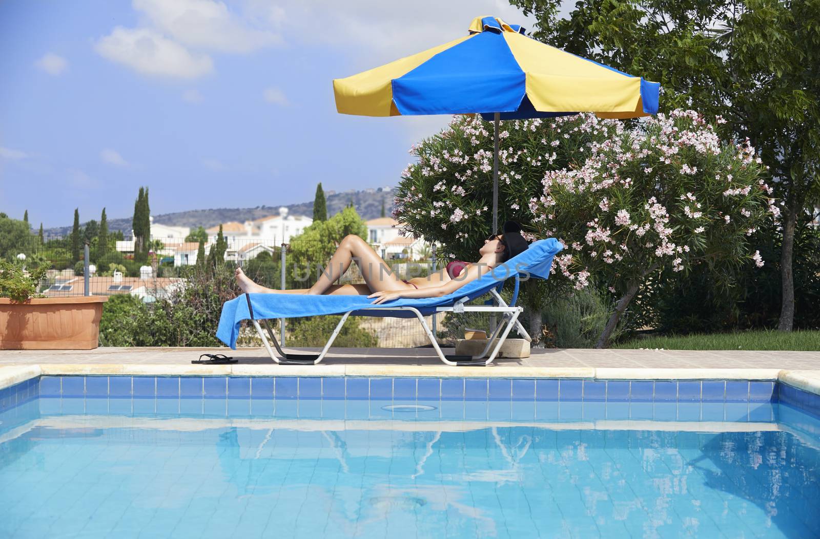 Young Woman Sunbathing In Bikini by gemphotography