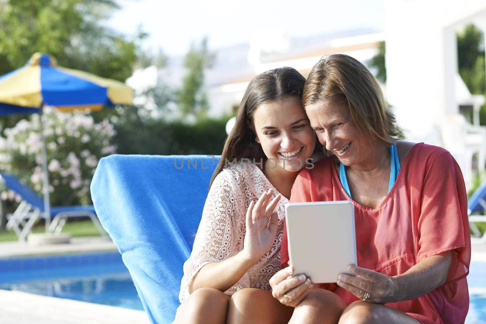 Mother and Daughter Skpying On Digital Tablet by gemphotography