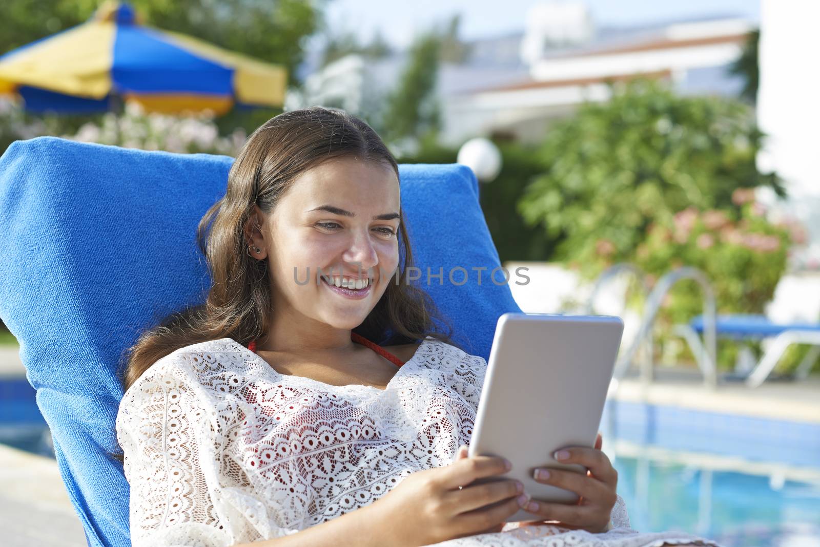 Young girl using digital tablet by gemphotography