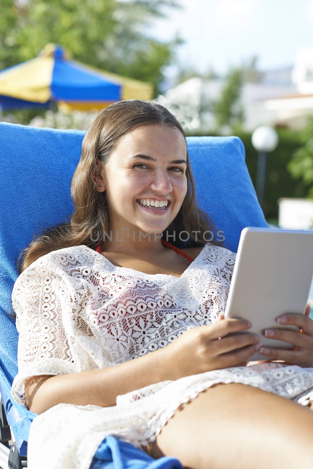 Young girl using digital tablet by gemphotography