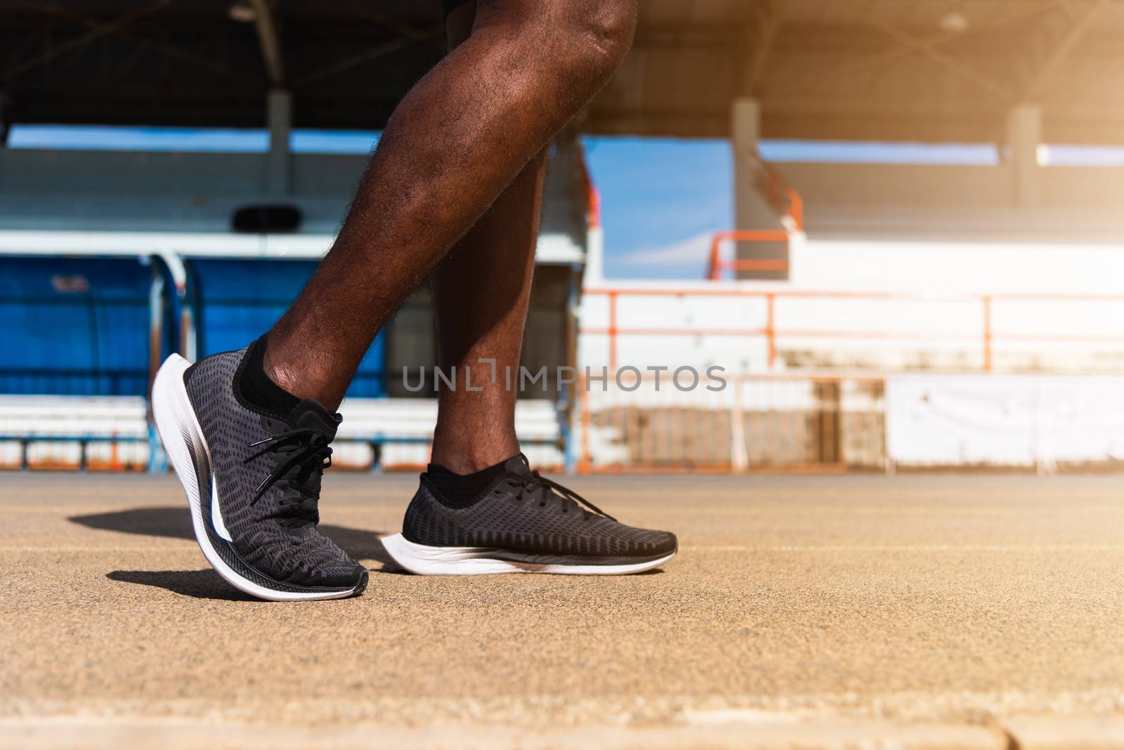 Asian young athlete sport runner black man wear feet active ready to running training at the outdoor on the treadmill line road for a step forward, healthy exercise workout, closeup back shoe