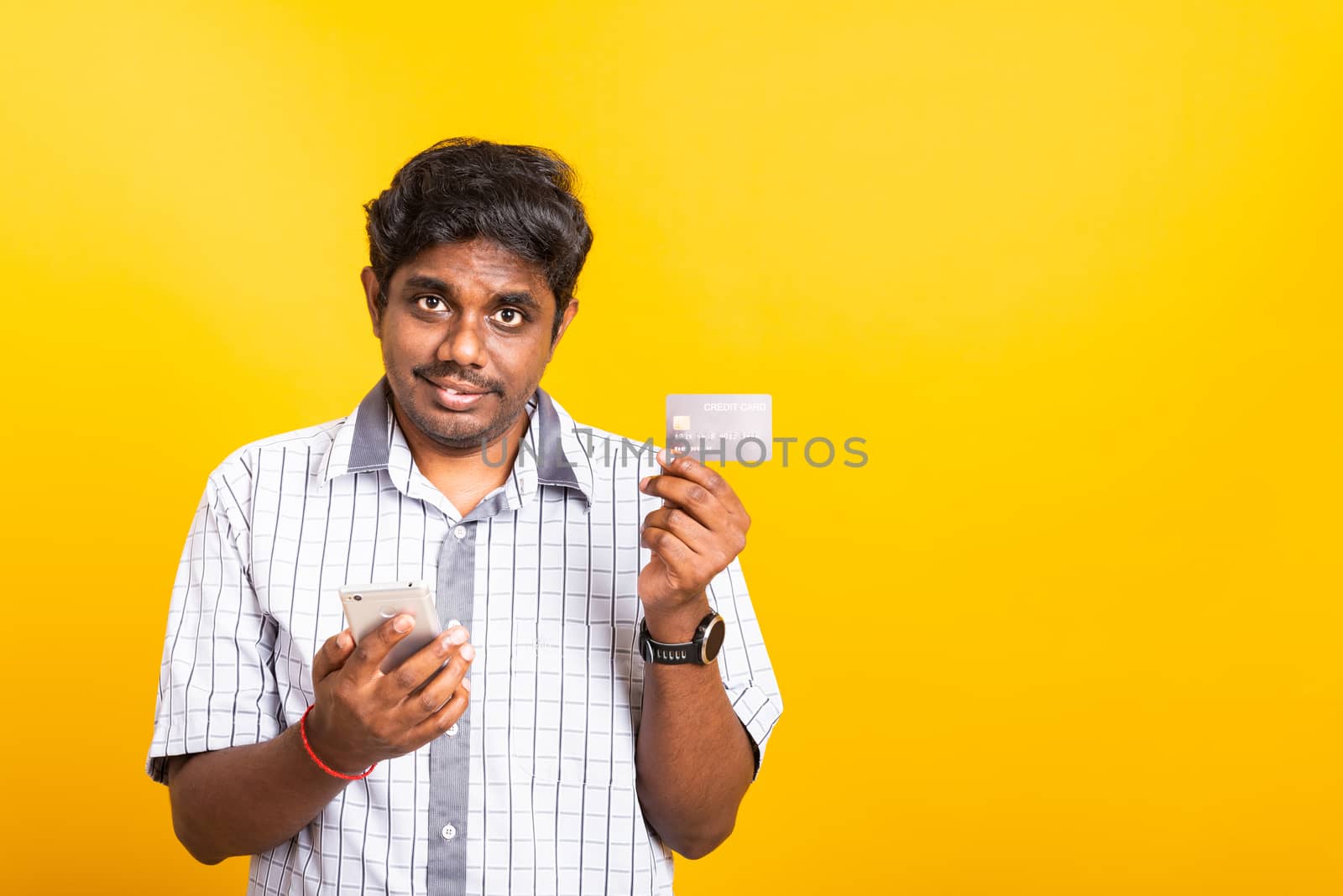 black man holds a mobile smartphone and showing credit card by Sorapop