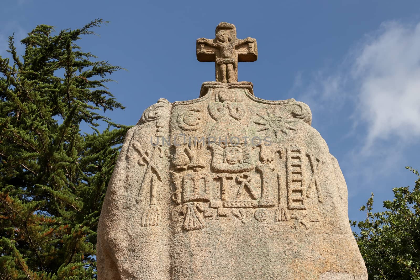 Menhir of Saint-Uzec. Menhir is about eight meters high and three meters wide. It is the largest menhir in France with Christian symbols. Pleumeur-Bodou, Brittany, France.