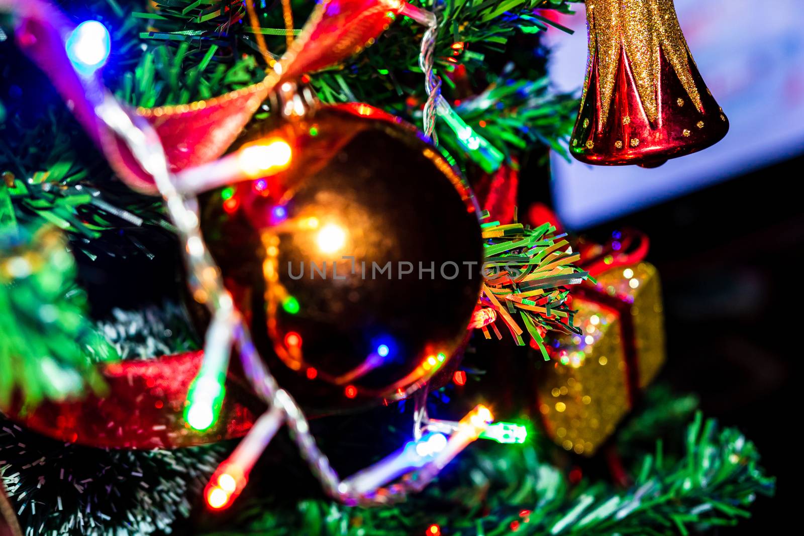 Christmas hanging decorations on fir tree. Decorated Christmas tree. Fir branch with Christmas baubles decorations.