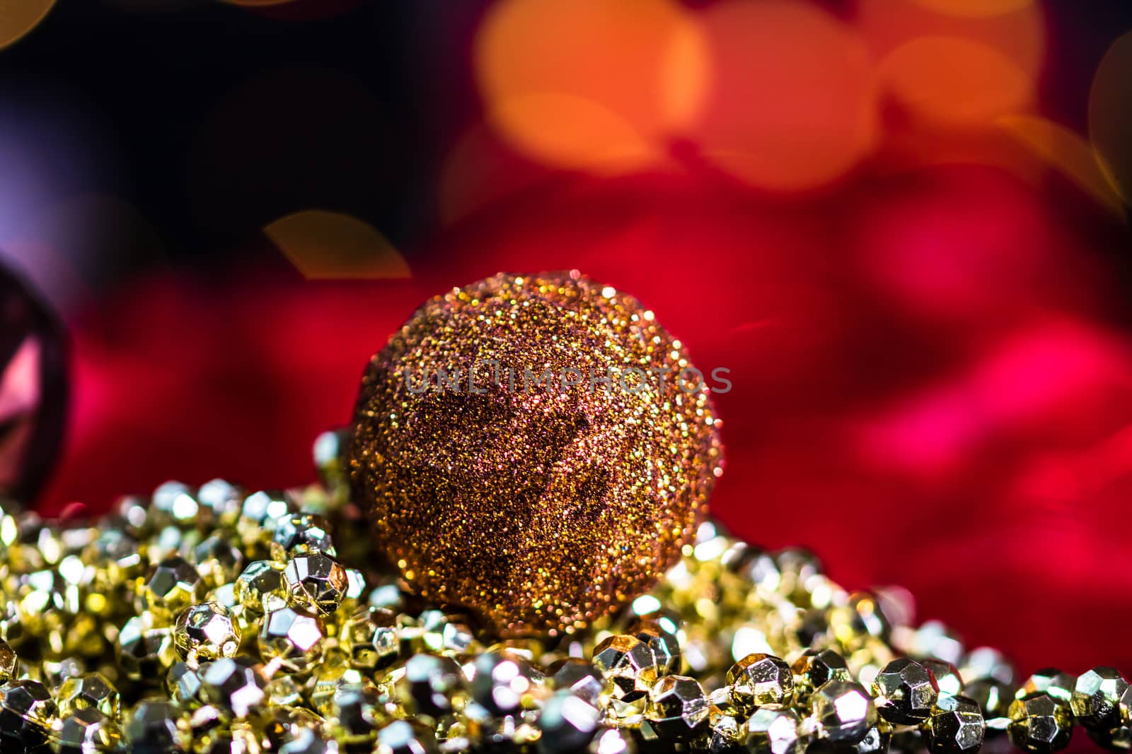 Decorations and ornaments in a colorful Christmas composition isolated on background of blurred lights.