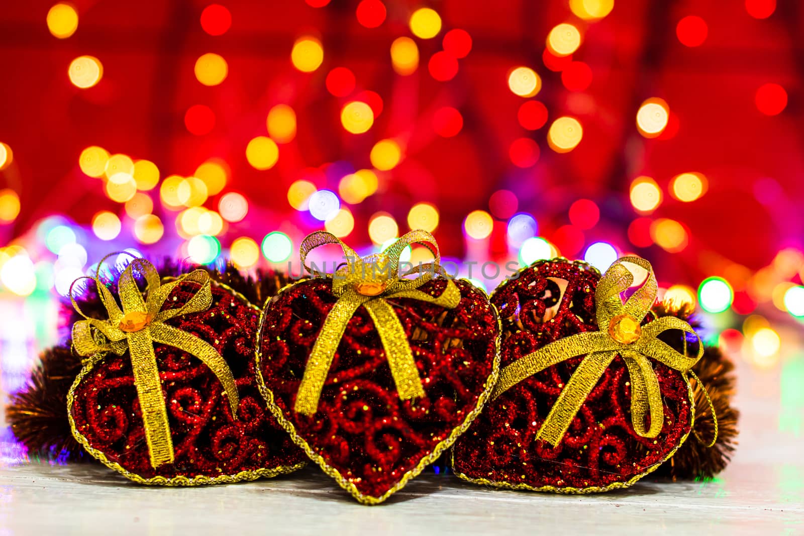 Decorations and ornaments in a colorful Christmas composition isolated on background of blurred lights.