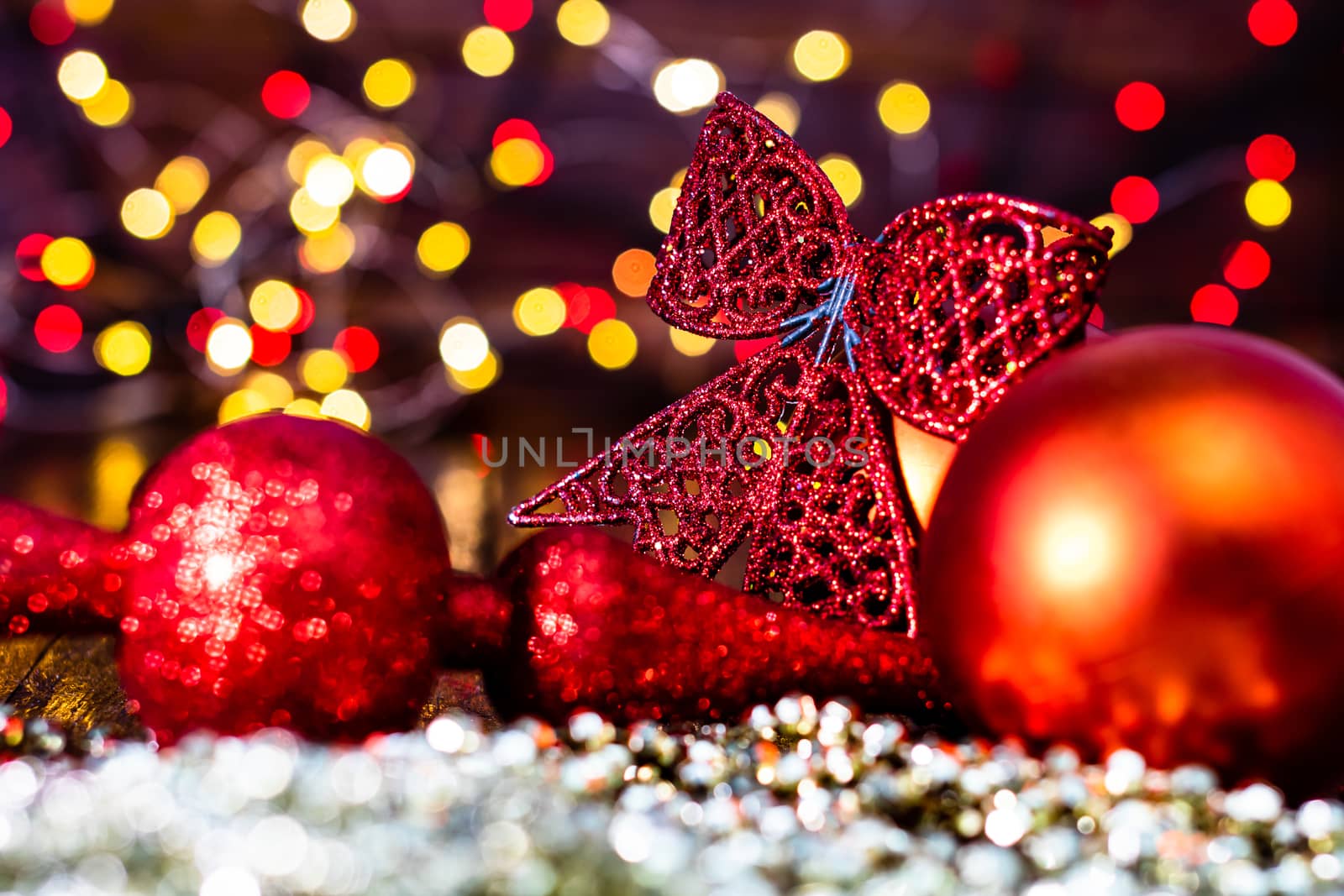 Decorations and ornaments in a colorful Christmas composition isolated on background of blurred lights.