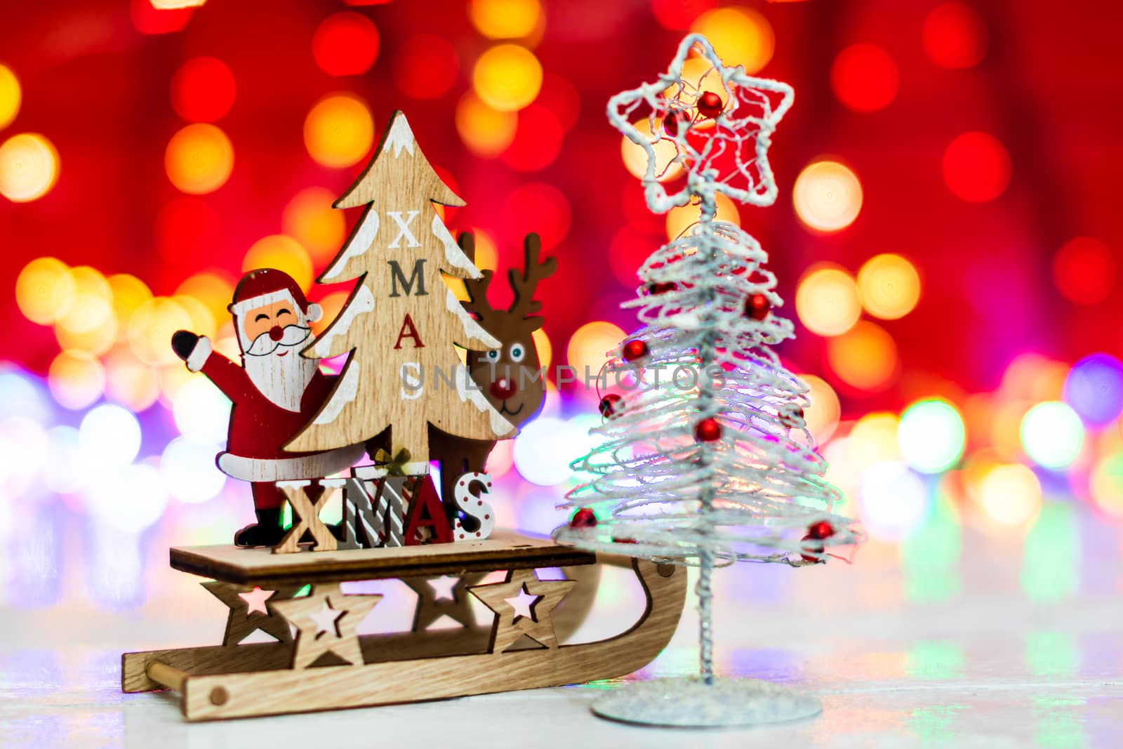 Decorations and ornaments in a colorful Christmas composition isolated on background of blurred lights.