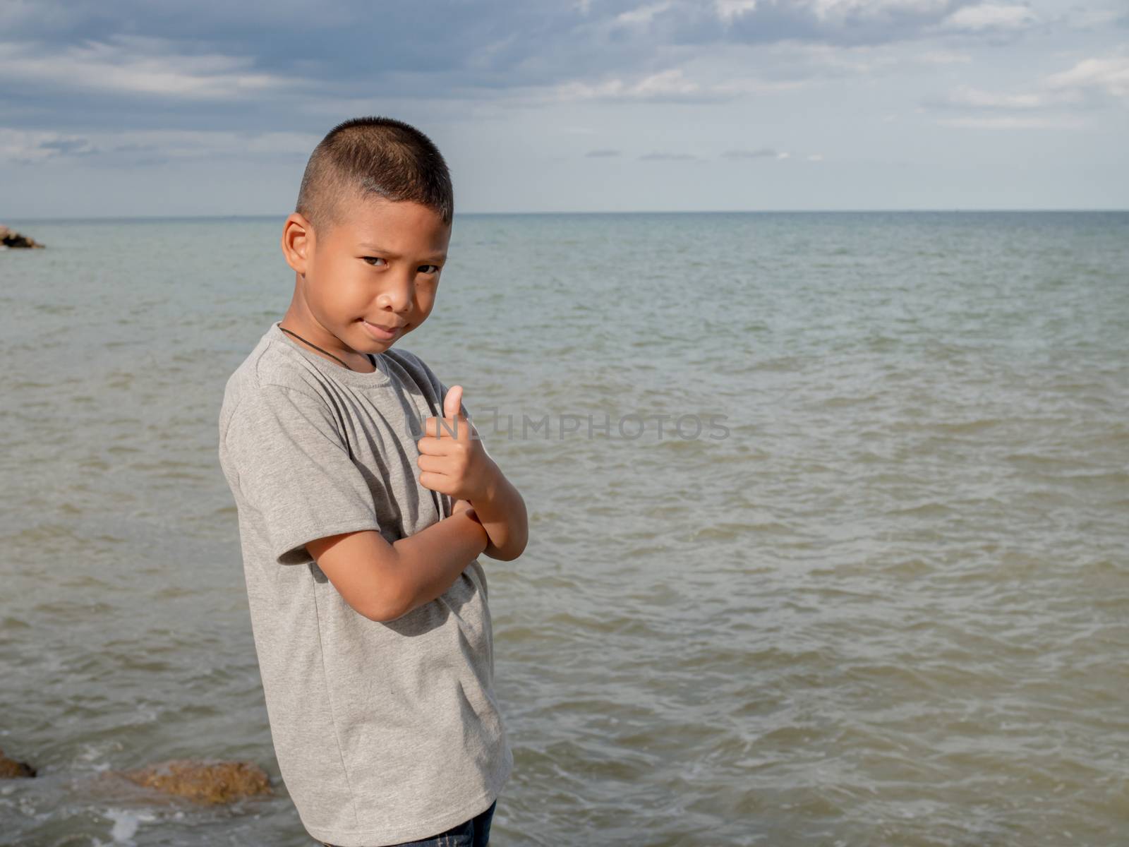 Portrait of a boy On wearing a gray shirt On the background of t by Unimages2527