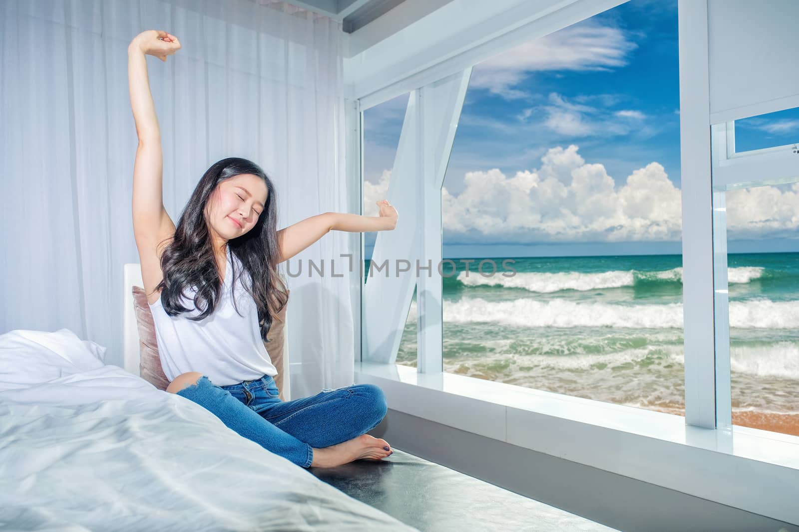 Woman stretch herself out after waking up in the morning on white background