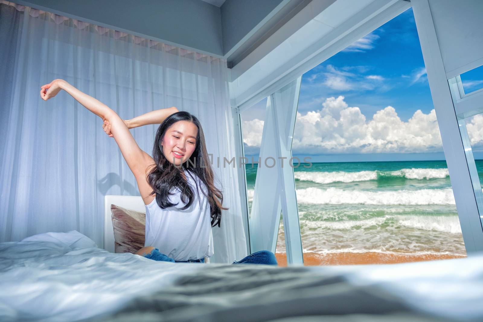 Woman stretch herself out after waking up in the morning 