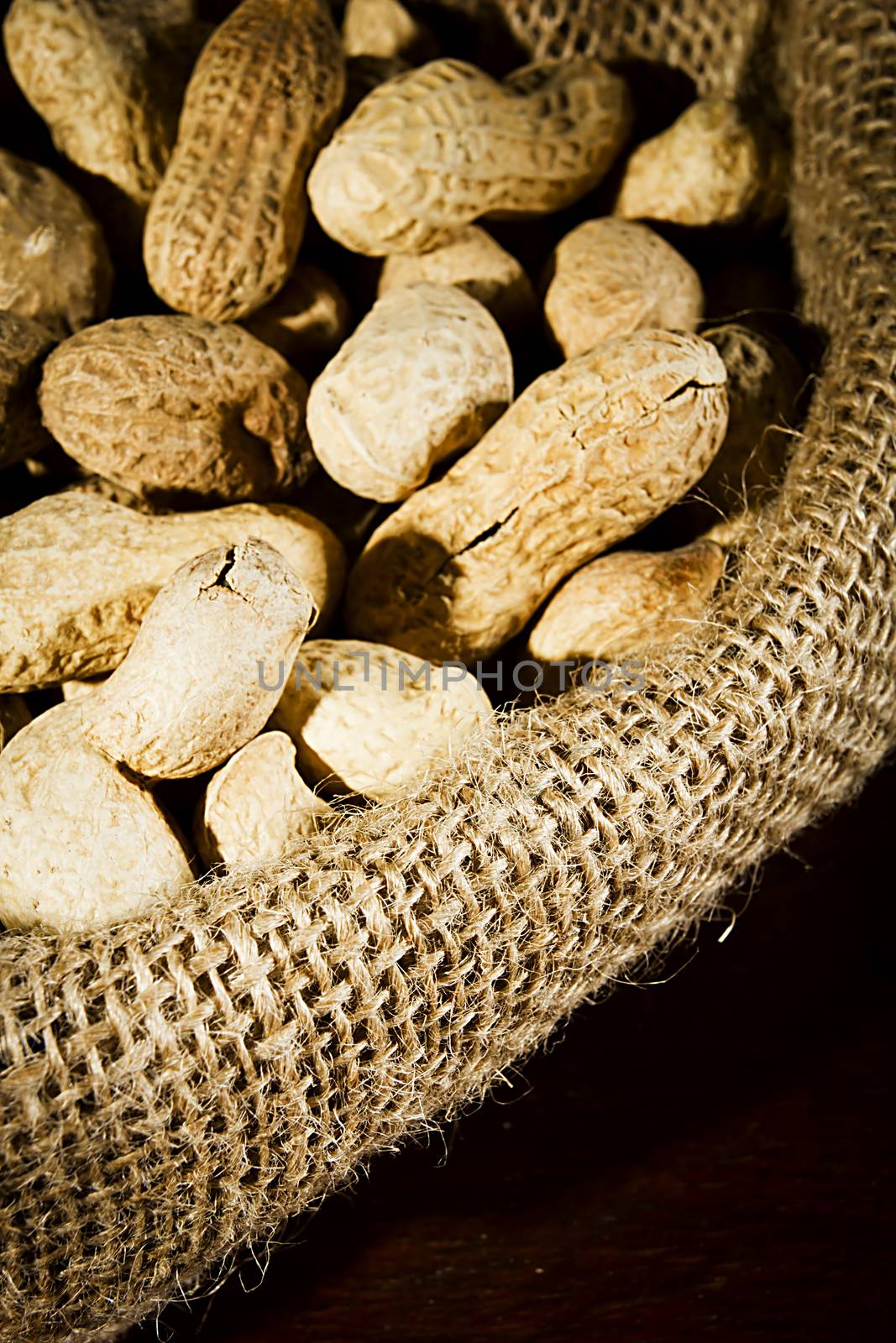 Unpeeled peanuts in a bag close up
