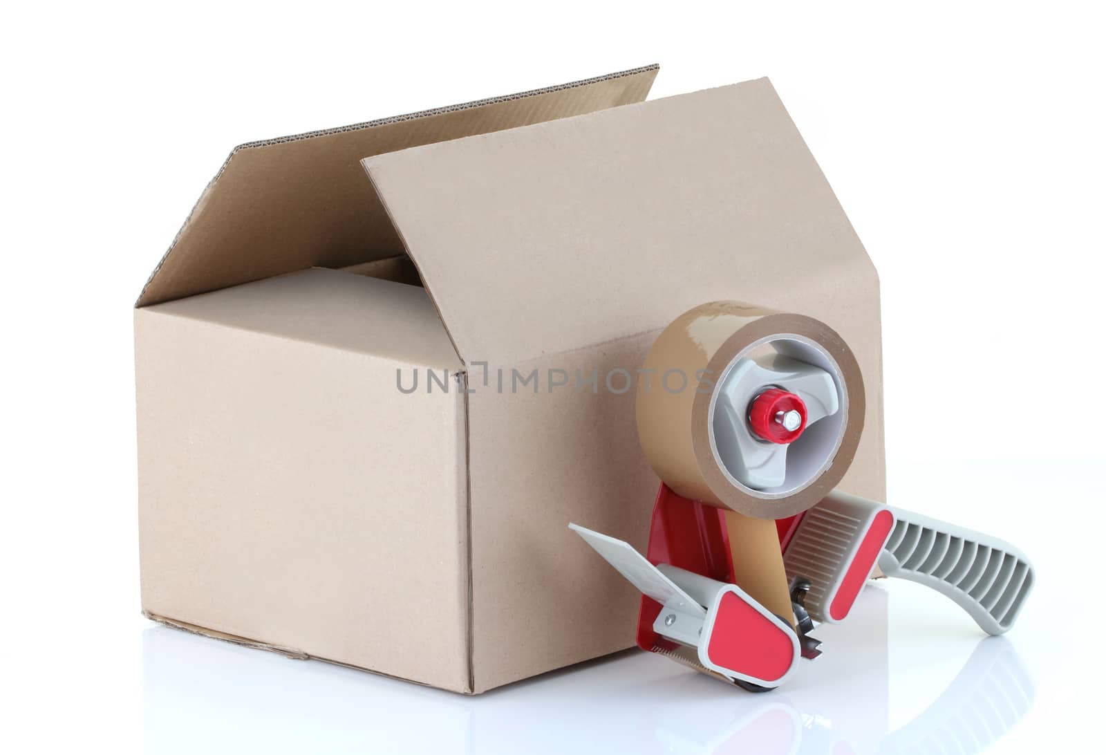 A cardboard box and packing tape gun on white