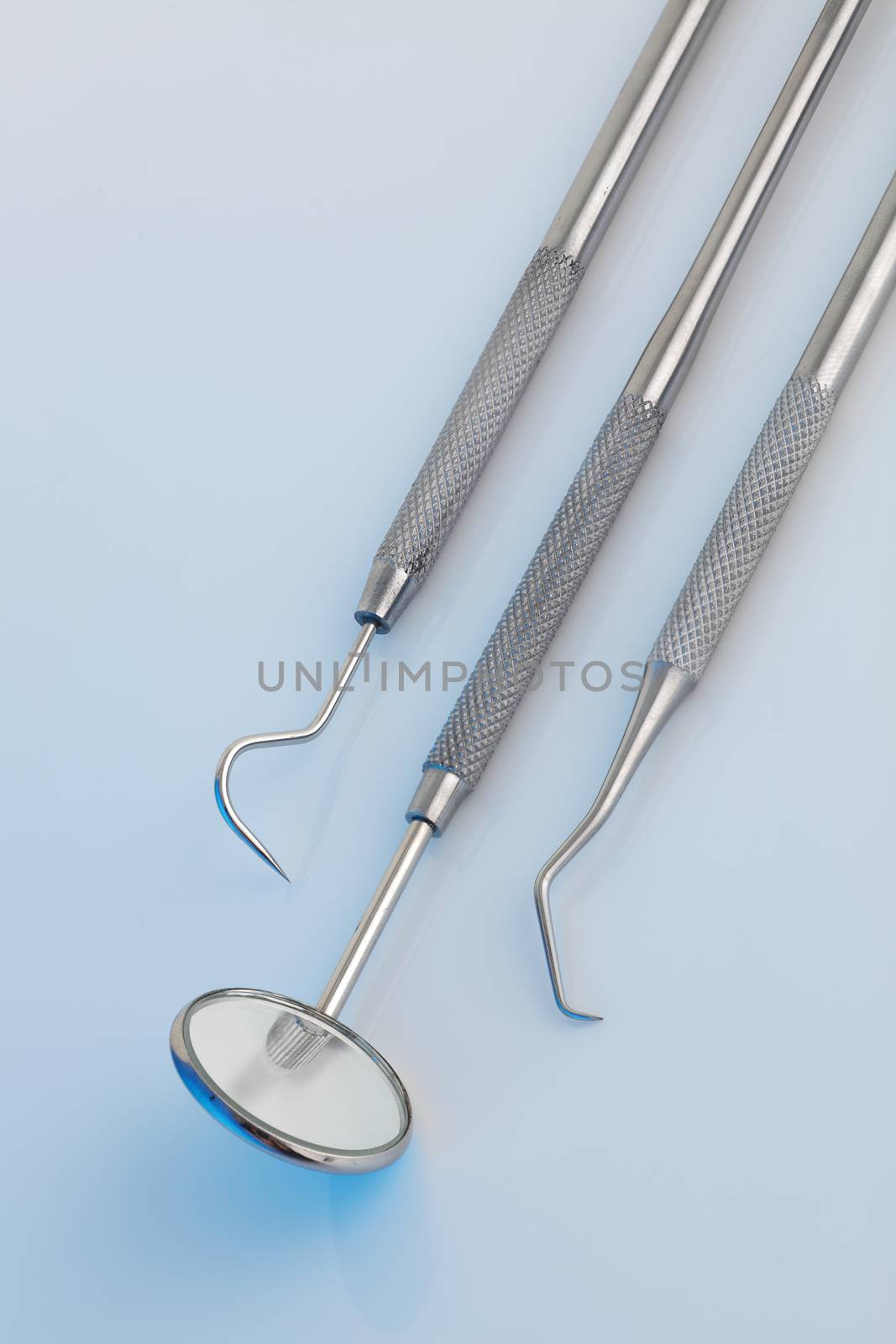 Dental tools in a clinical blue light by VivacityImages
