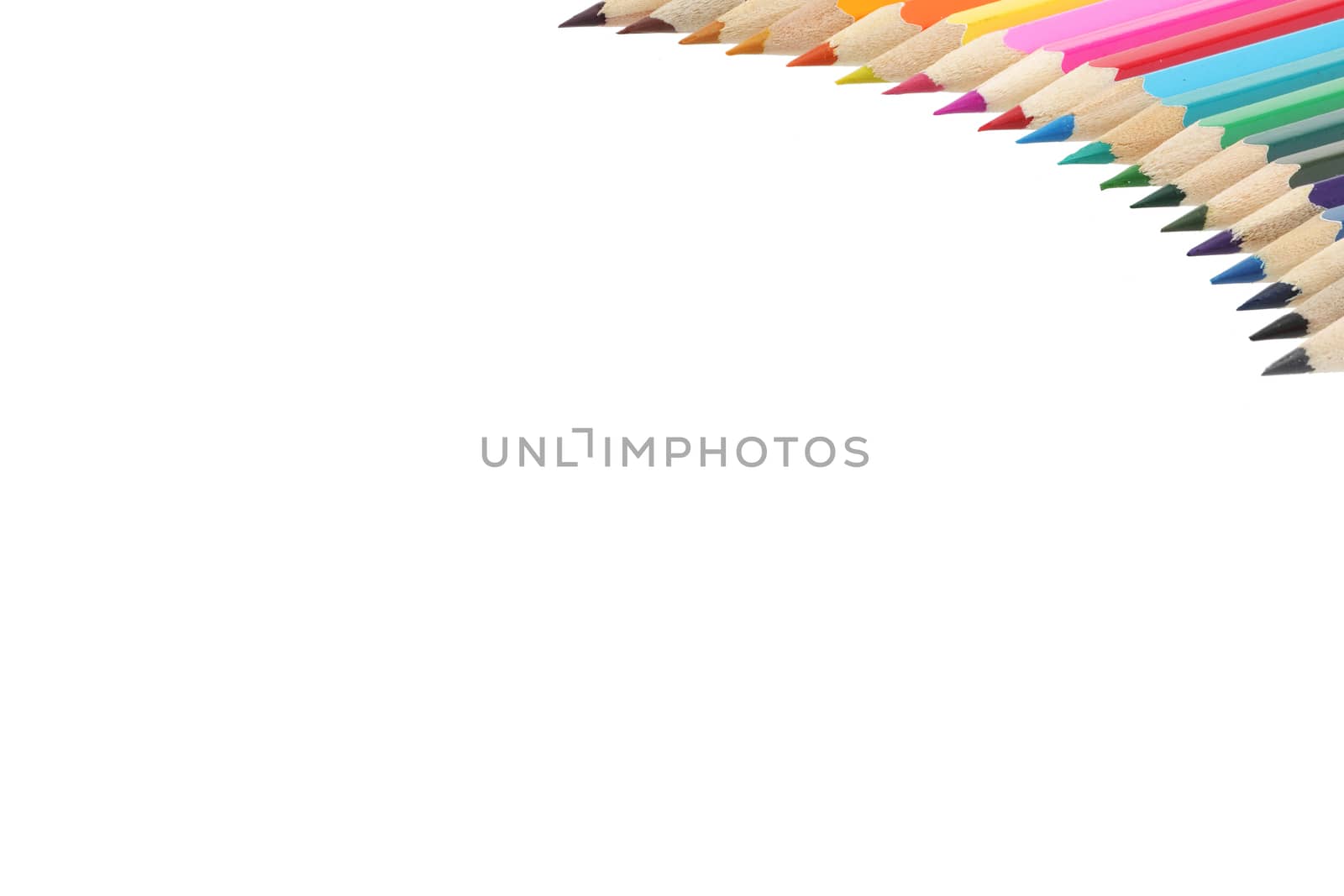 A top right corner border of multi colored pencils with copy space