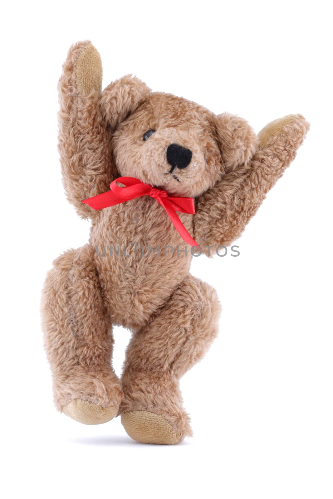 A jumping brown Teddy bear with red ribbon on white background