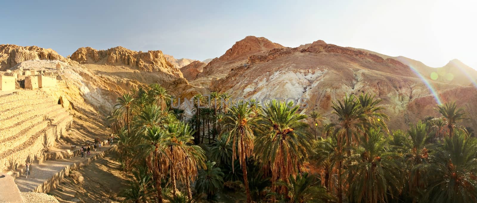 Wide panorama of Chebika oasis with Atlas mountains in midday su by Ivanko