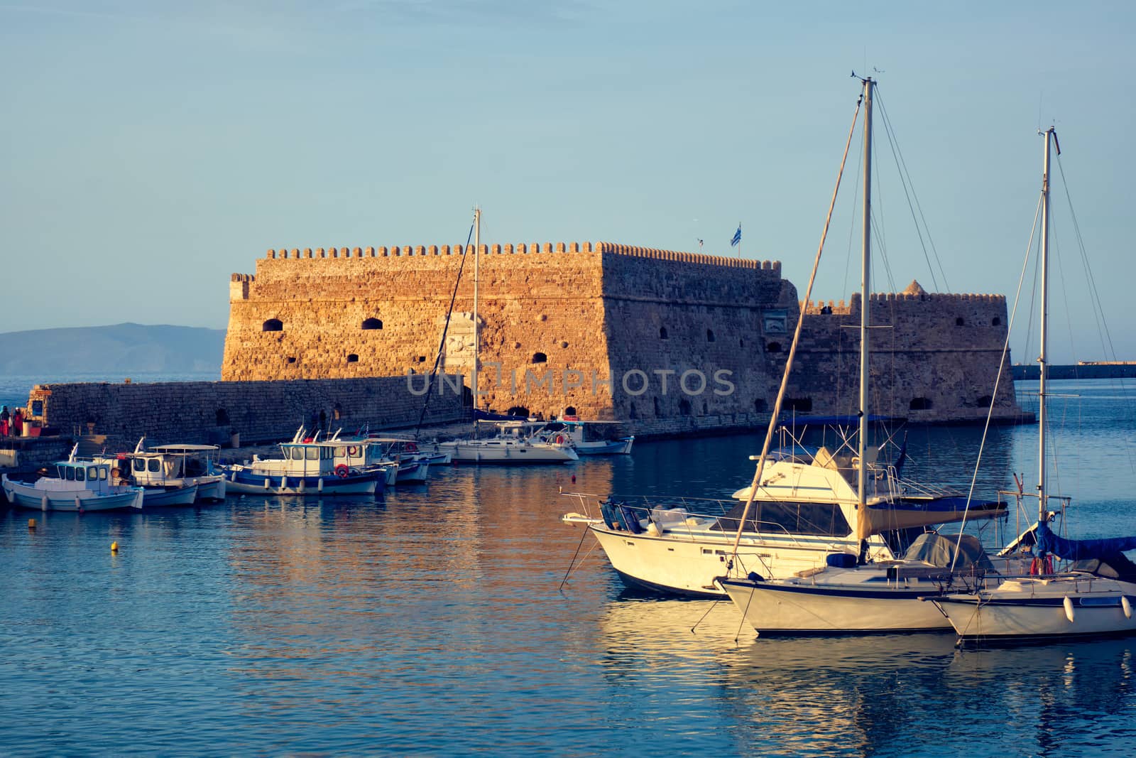 Venetian Fort in Heraklion and moored fishing boats, Crete Island, Greece by dimol