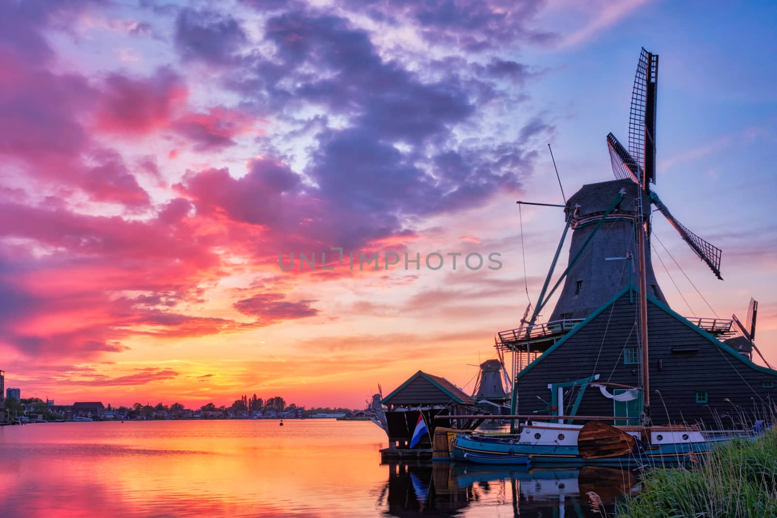 Windmills at Zaanse Schans in Holland on sunset. Zaandam, Nether by dimol