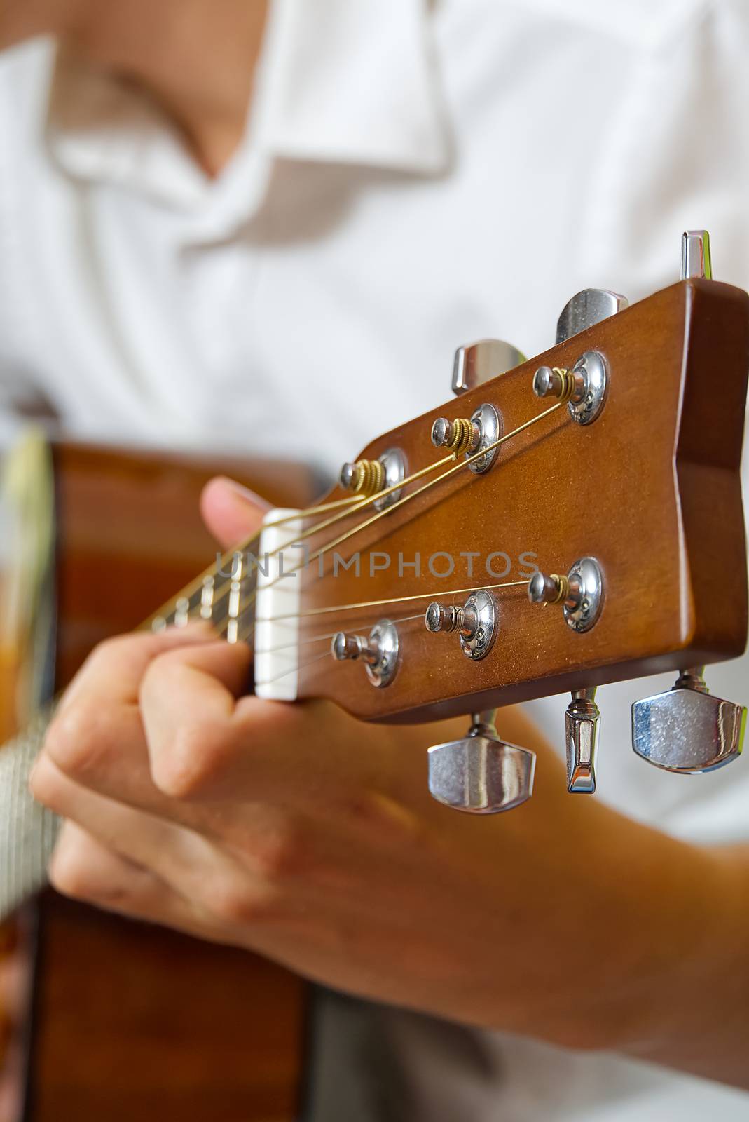 Young boy playing guitar. Close-up of man hand playing classic guitar. teenager learning playing guitar. by PhotoTime
