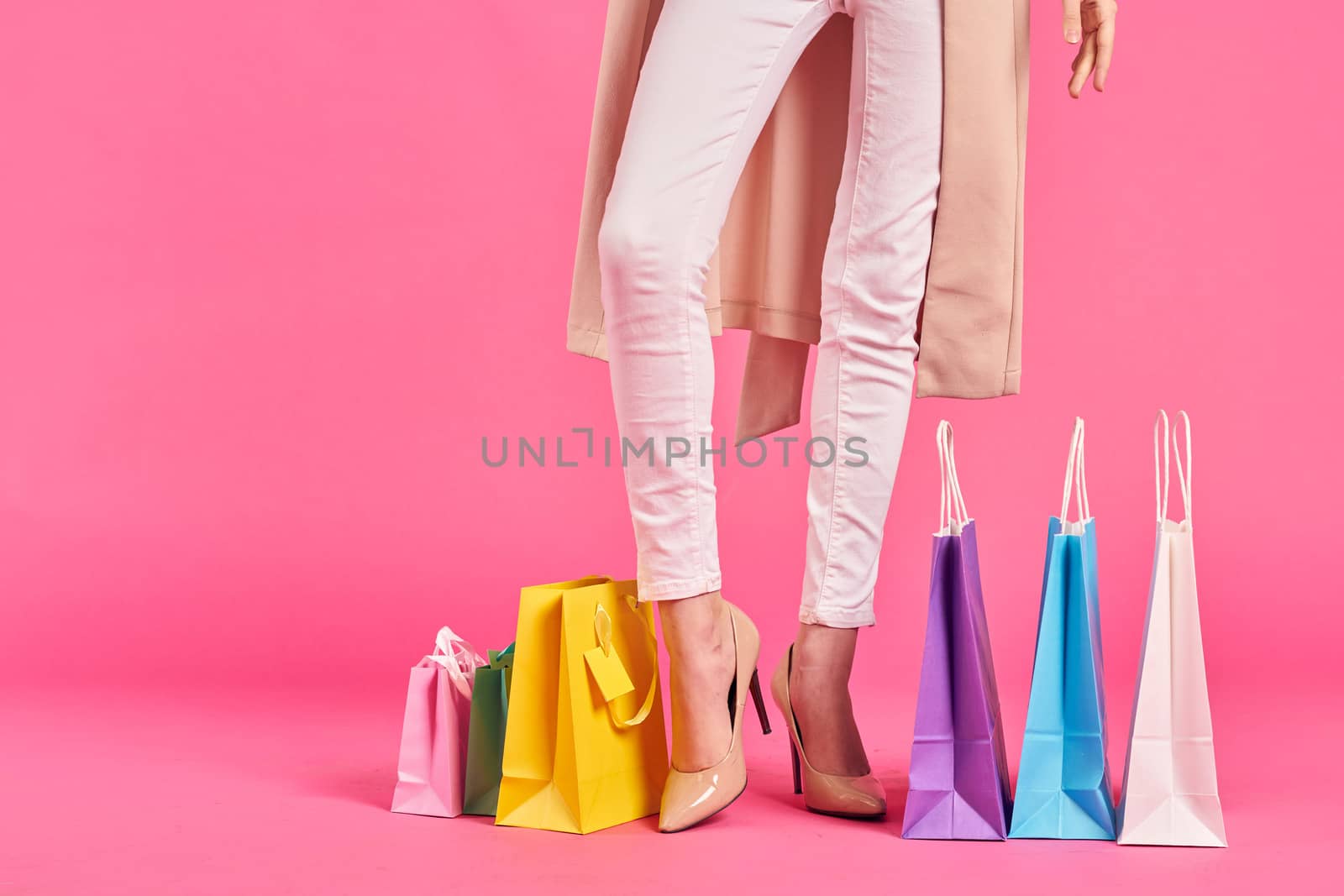 shopping bags female feet in shoes Shopaholic pink background by SHOTPRIME