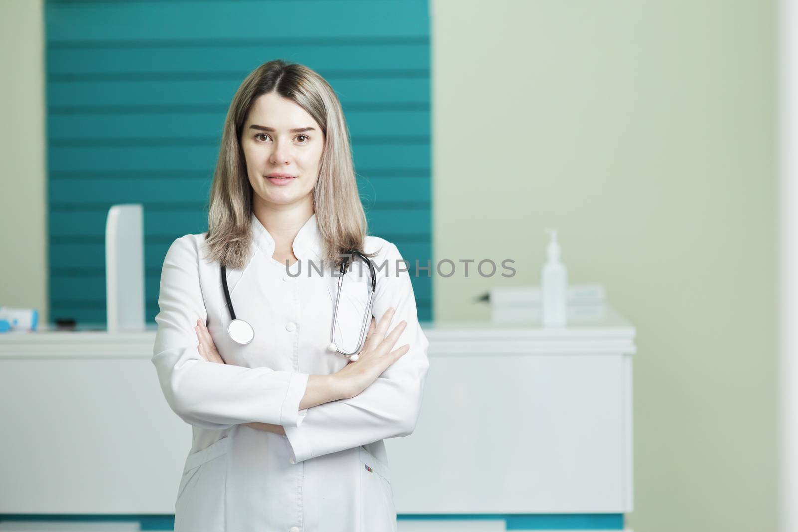 Female doctor or nurse in medical uniform, stethoscope on neck by selinsmo