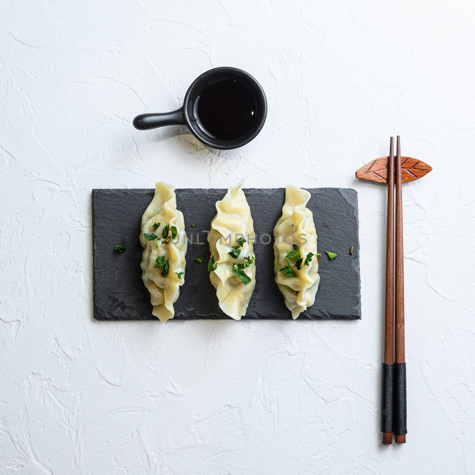 Japanese gyoza or dumplings snack with soy sauce Asian food on white background top view by Ilianesolenyi