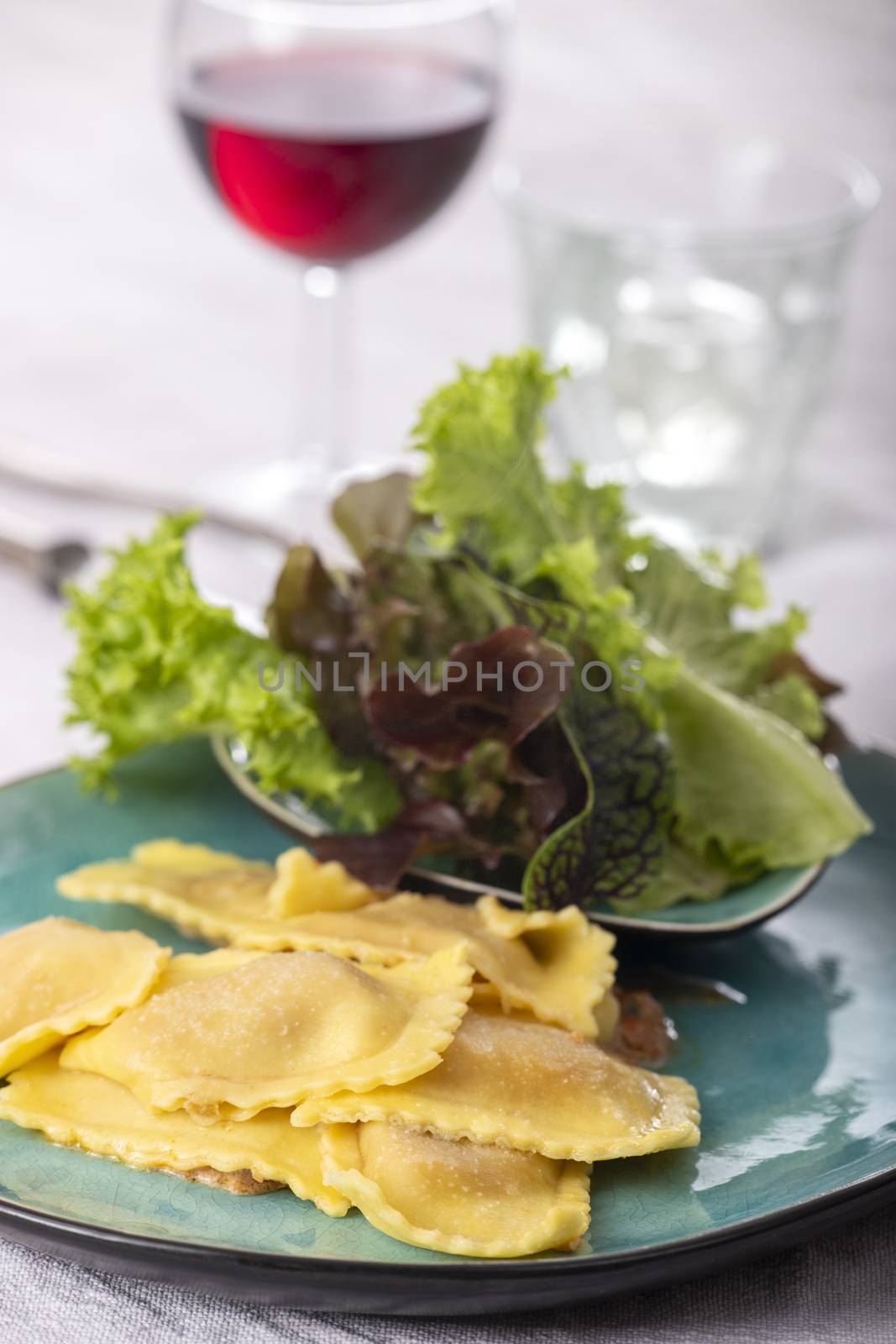 ravioli with cream sauce and salad