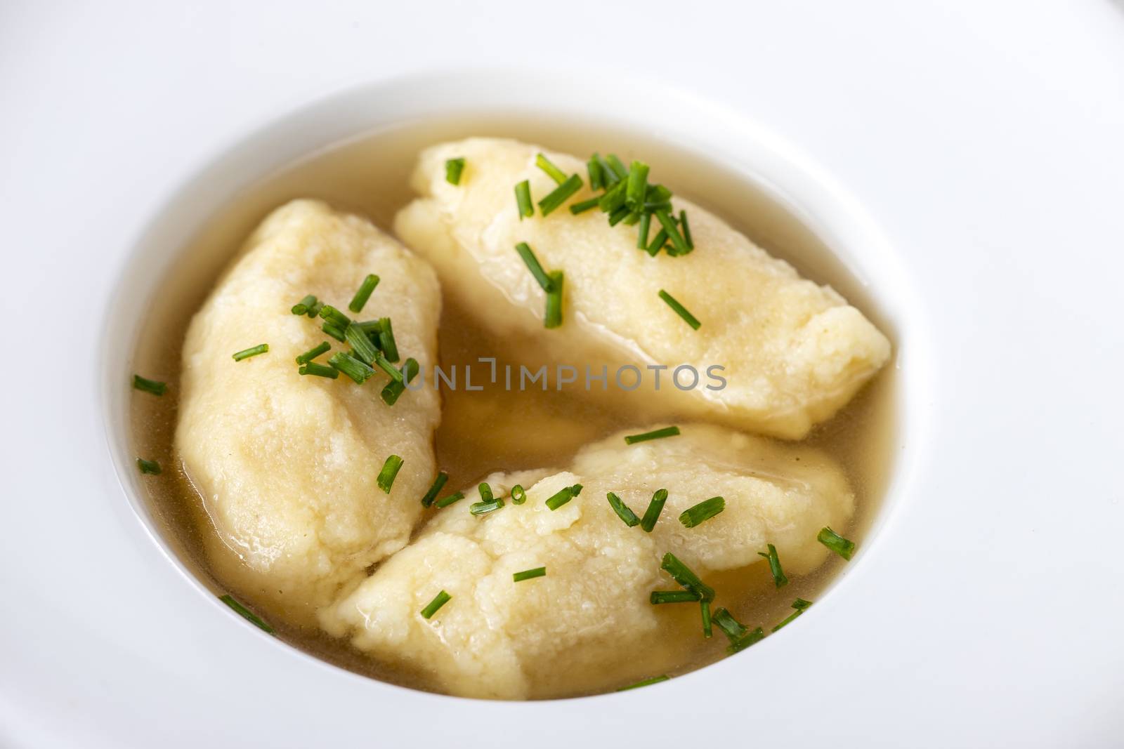 closeup of semolina dumplings in broth