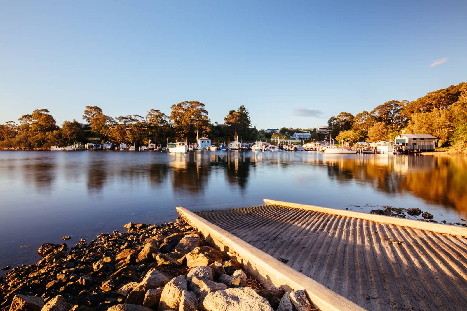 The idyllic setting across Wagonga Inlet at sunset in Narooma, NSW, Australia
