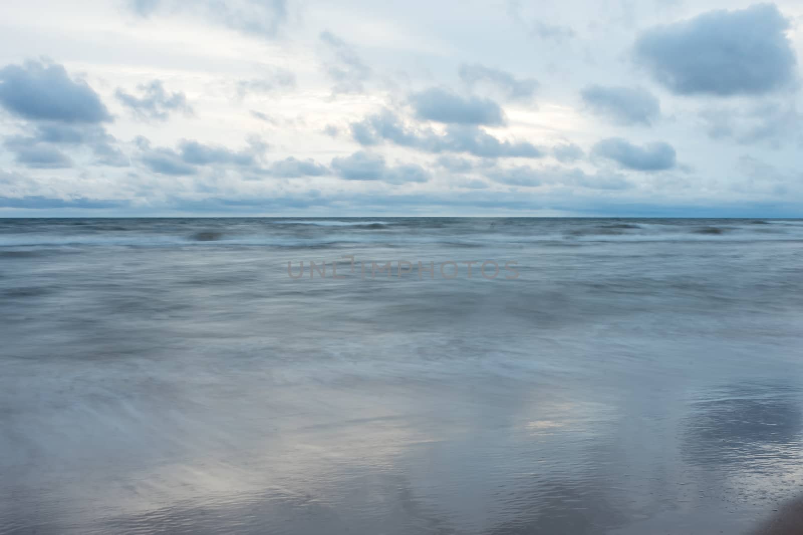 running clouds over the sea in the evening