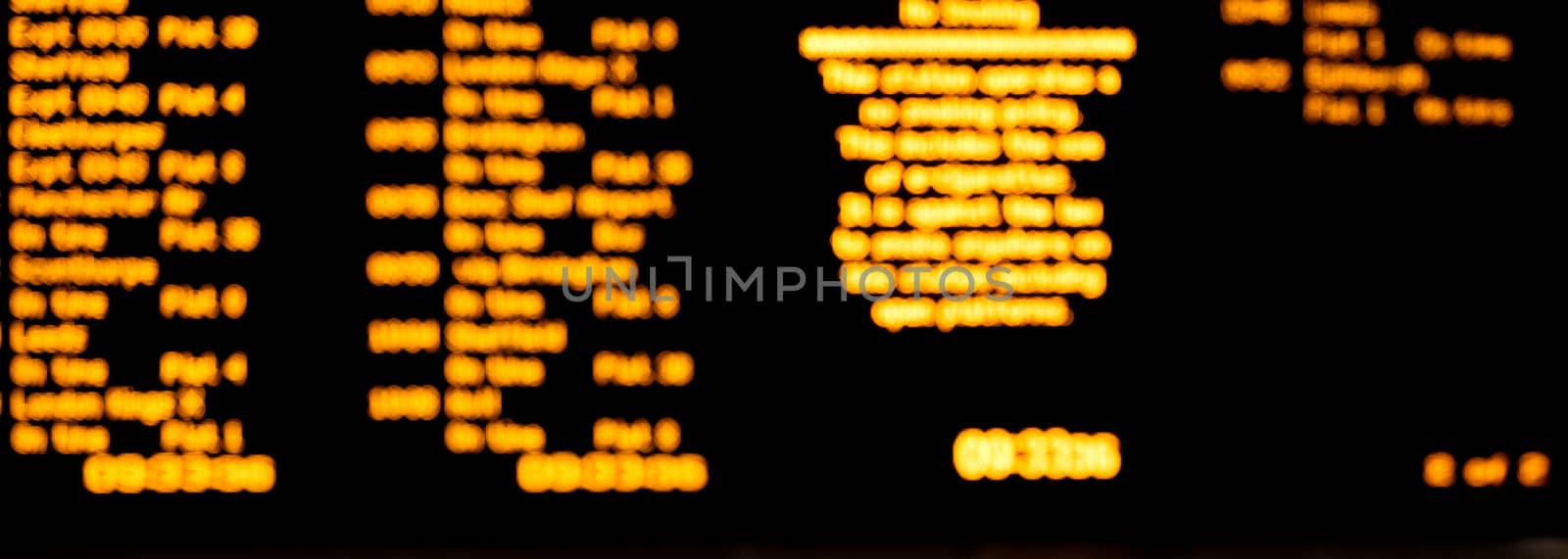 blurred led train schedule text on black background by Iryna_Melnyk