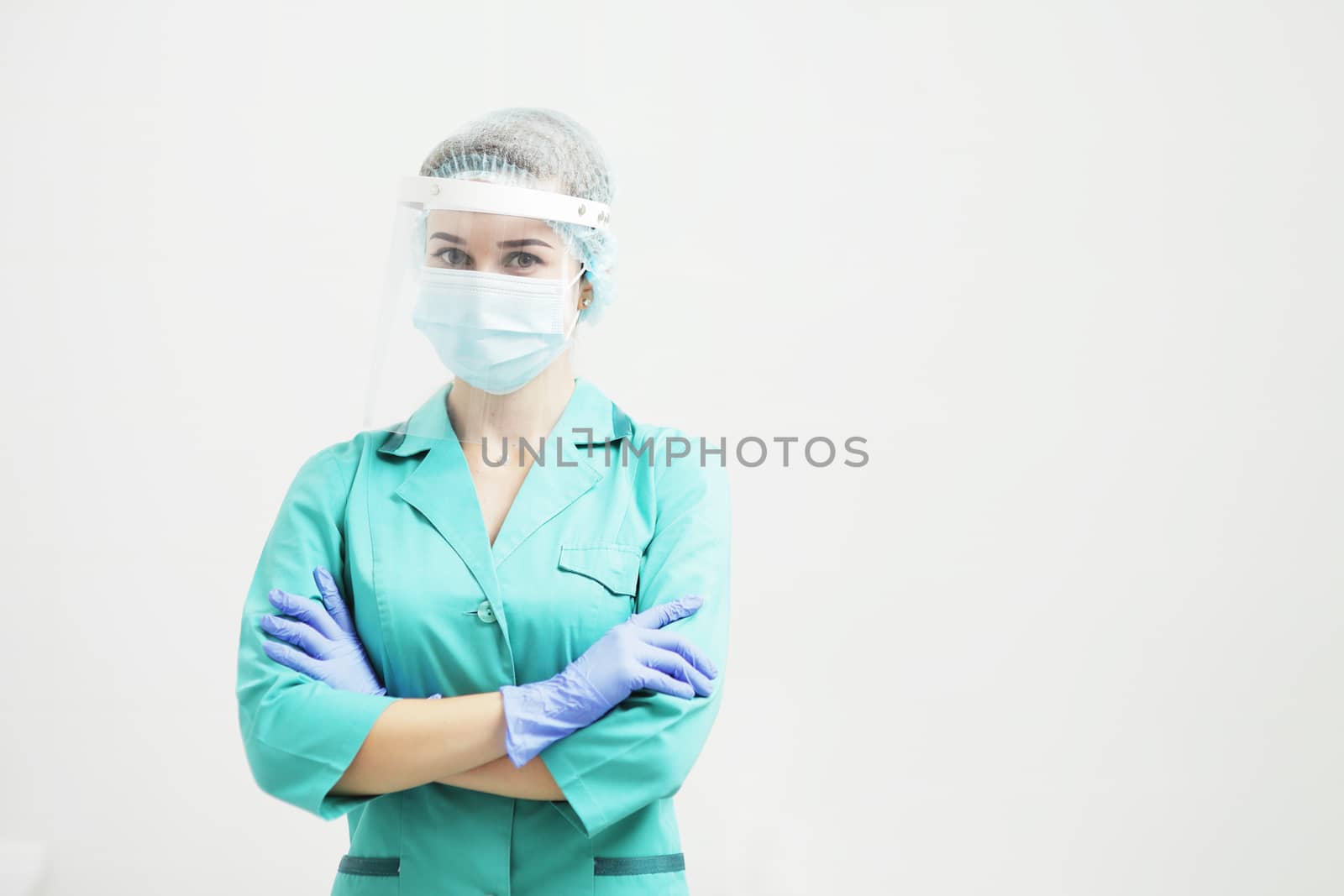 Female doctor or nurse in a protective face mask. Safety measures against the coronavirus. Prevention Covid-19 healthcare concept. Protective gloves on hands
