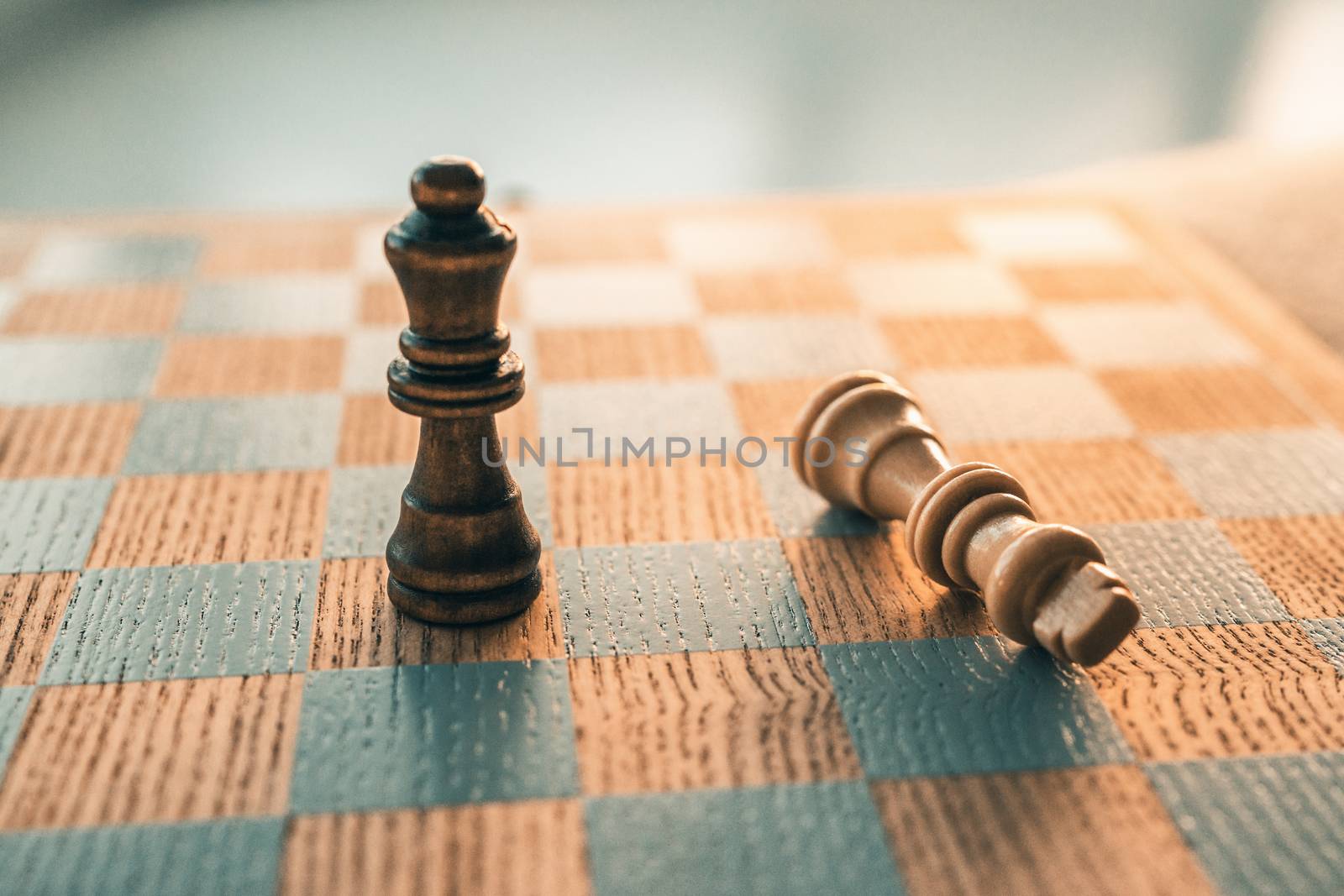 Chess game winning concept with last piece standing on chessboard wooden board.