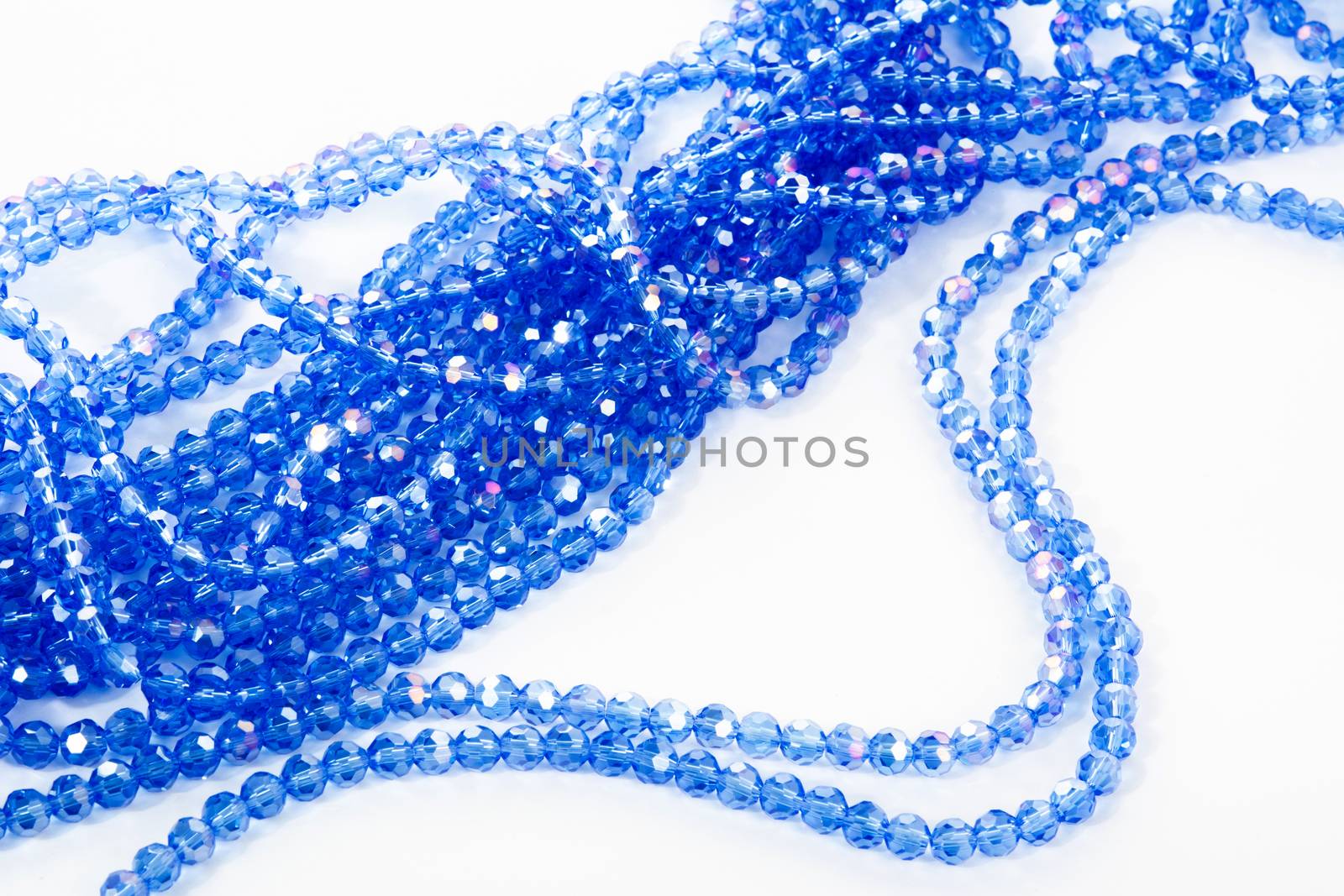 Beautiful blue Glass Sparkle Crystal Isoalted Beads on white background. Use for diy beaded jewelry. Space for text