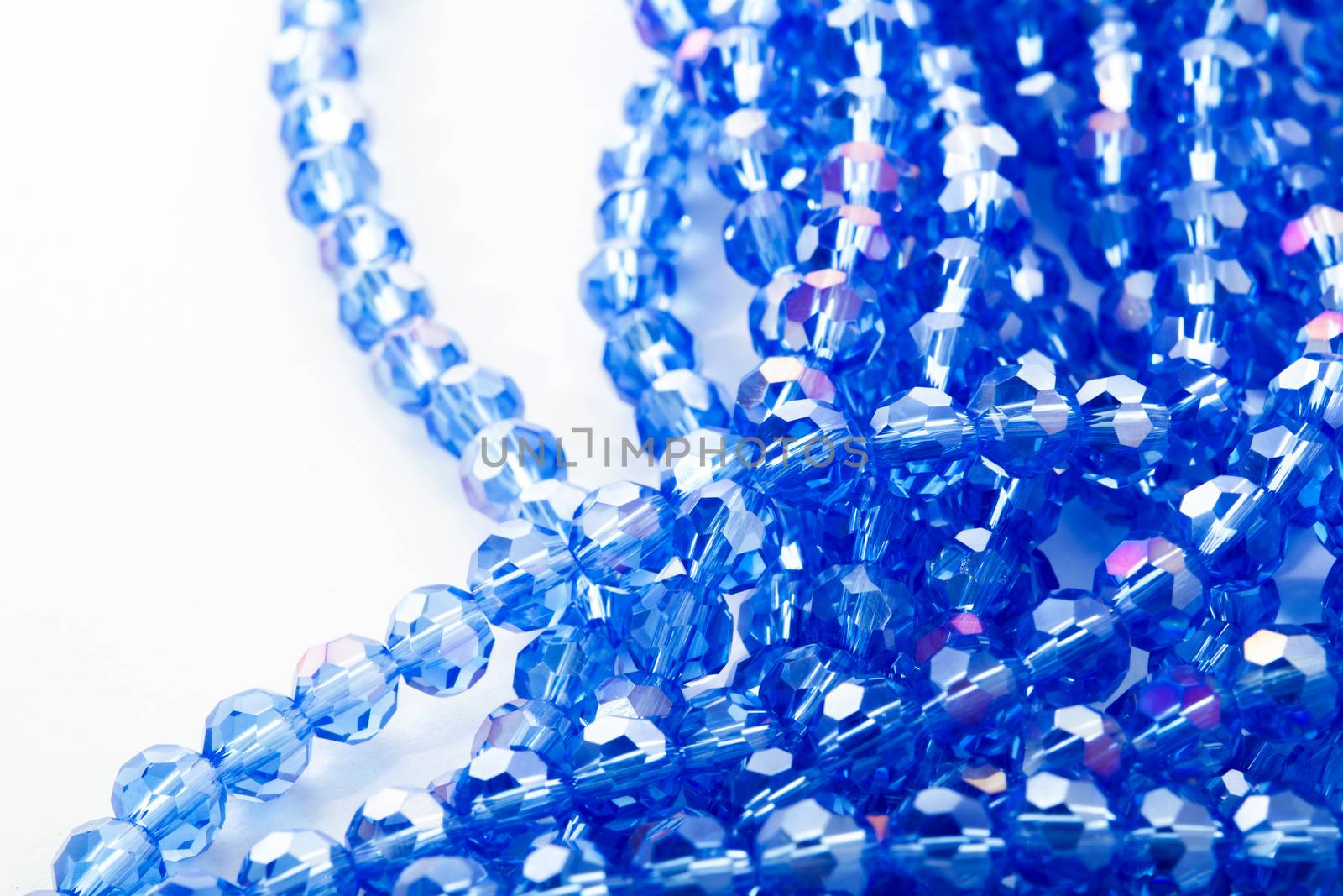 Beautiful blue Glass Sparkle Crystal Isoalted Beads on white background. Use for diy beaded jewelry. Space for text