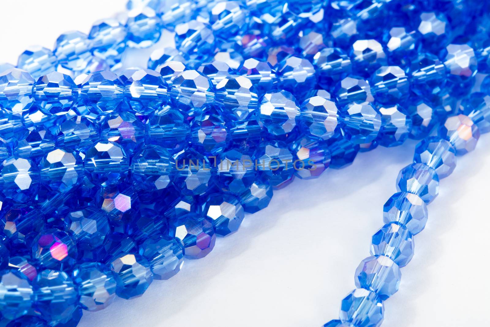 Beautiful blue Glass Sparkle Crystal Isoalted Beads on white background. Use for diy beaded jewelry. Space for text