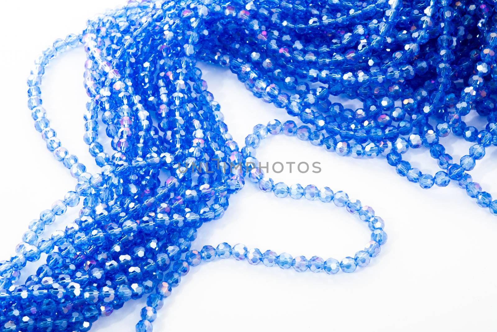 Beautiful blue Glass Sparkle Crystal Isoalted Beads on white background. Use for diy beaded jewelry. Space for text