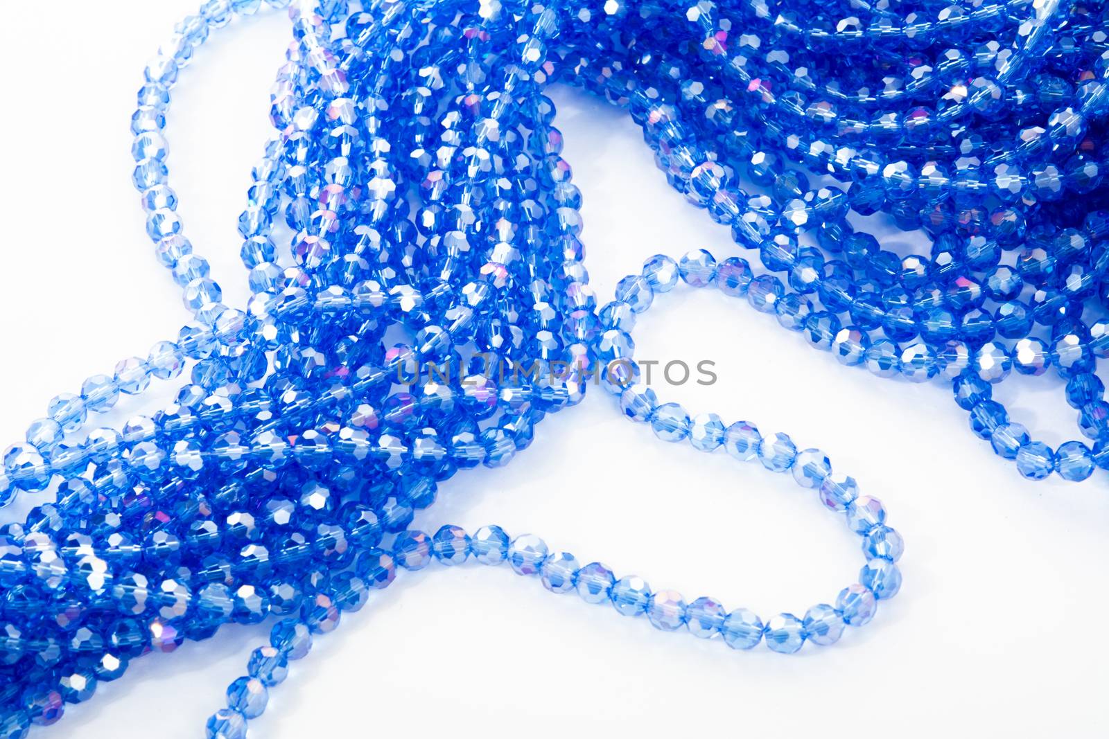 Beautiful blue Glass Sparkle Crystal Isoalted Beads on white background. Use for diy beaded jewelry. Space for text