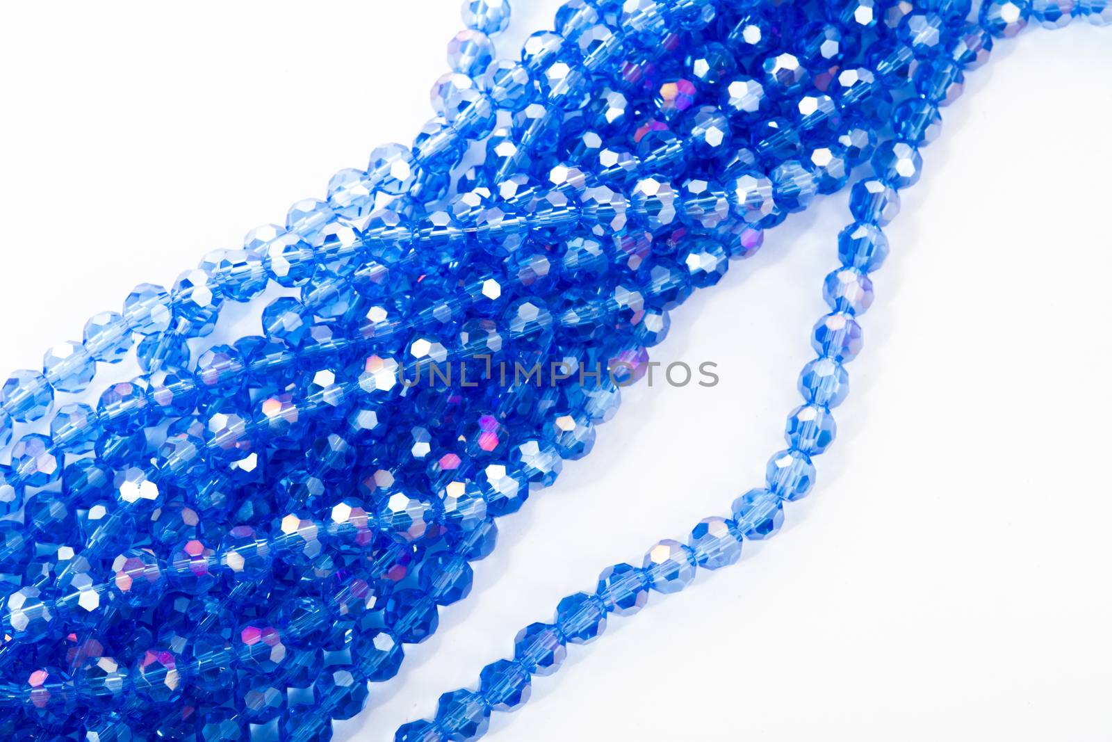 Beautiful blue Glass Sparkle Crystal Isoalted Beads on white background. Use for diy beaded jewelry. Space for text