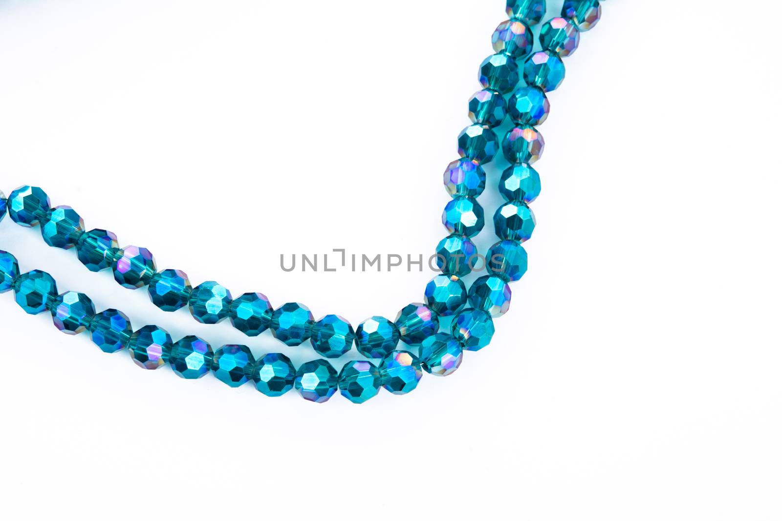 Beautiful emerald Glass Sparkle Crystal Isoalted Beads on white background. Use for diy beaded jewelry. Space for text