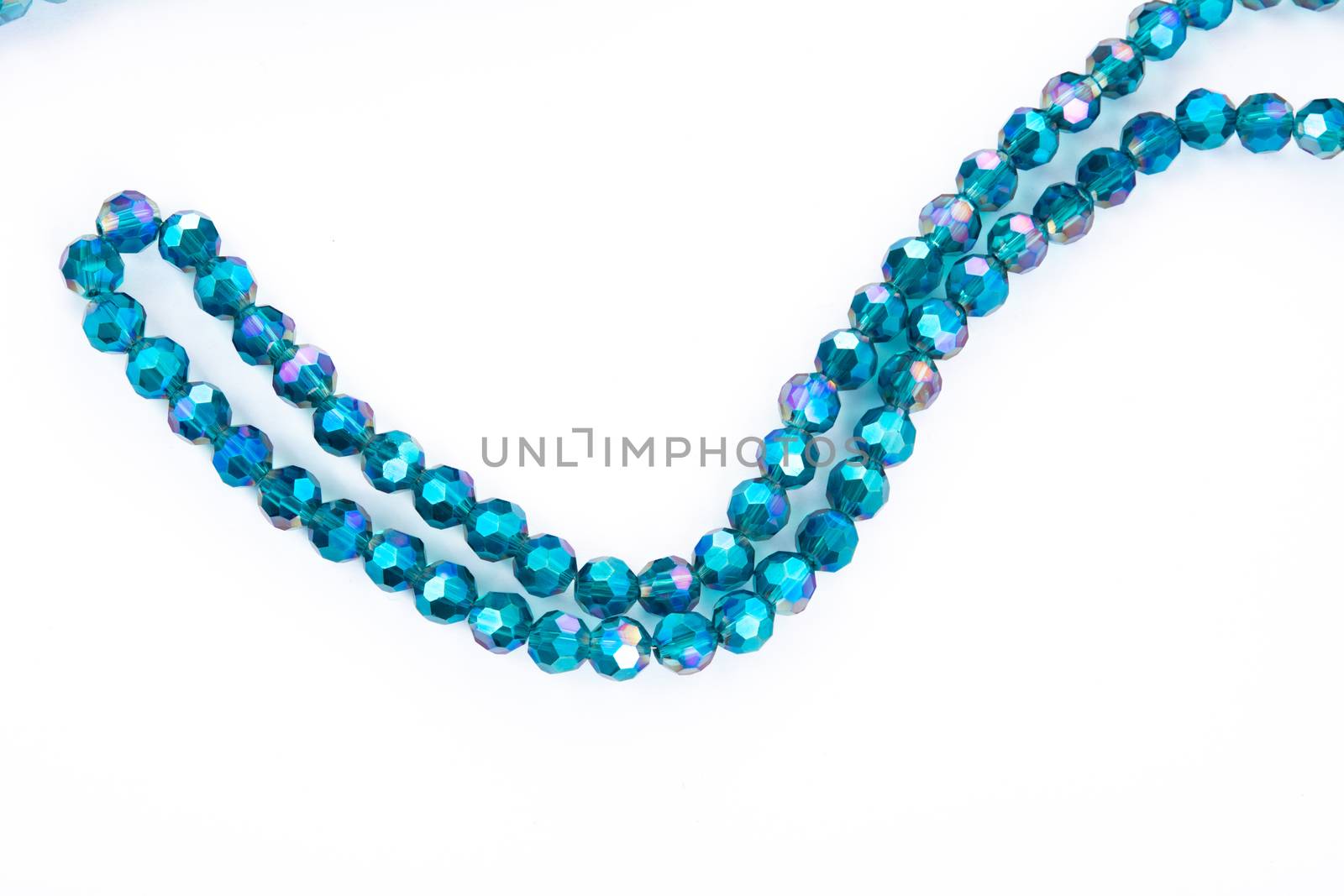Beautiful emerald Glass Sparkle Crystal Isoalted Beads on white background. Use for diy beaded jewelry. Space for text
