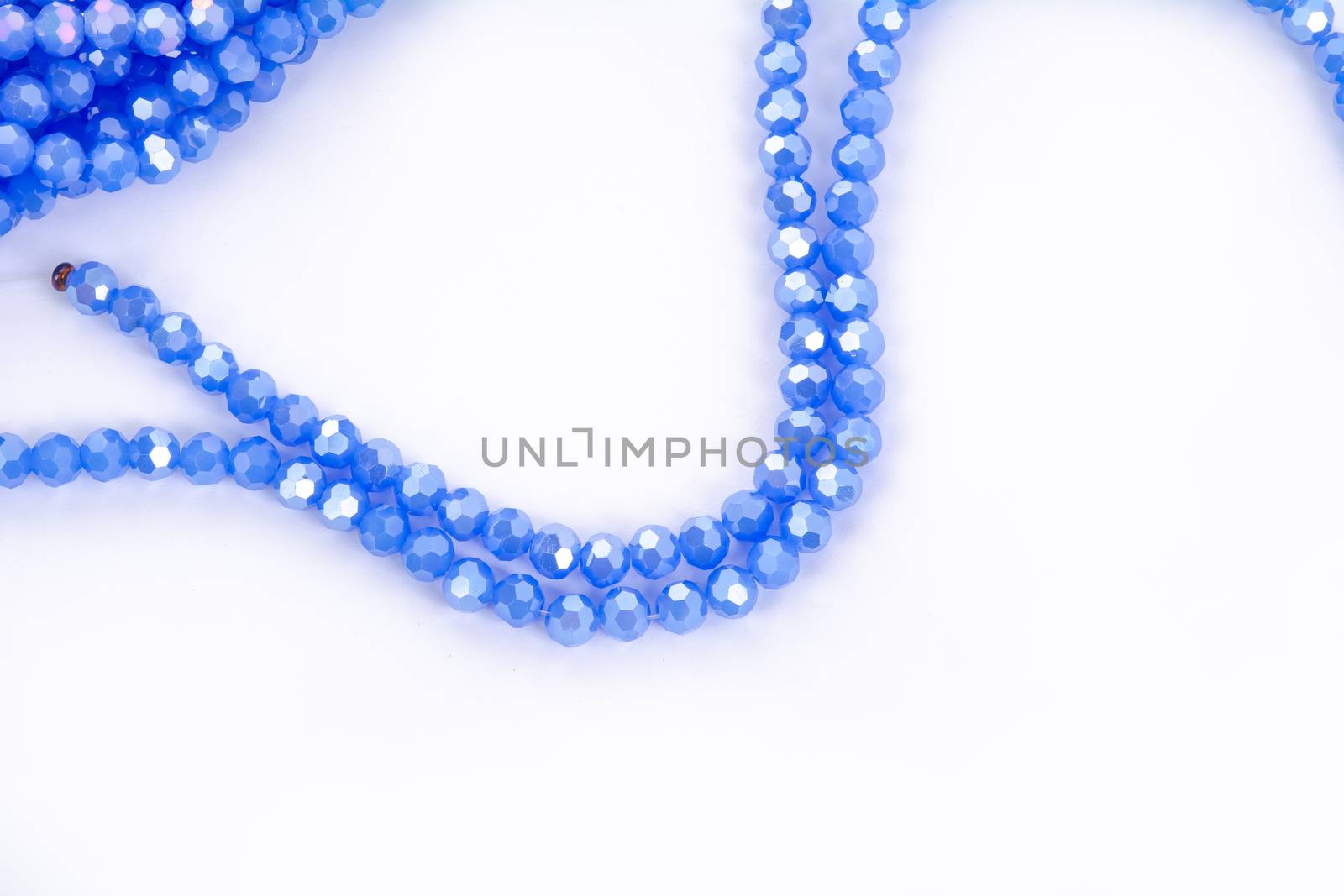 Beautiful blue Glass Sparkle Crystal Isoalted Beads on white background. Use for diy beaded jewelry. Space for text